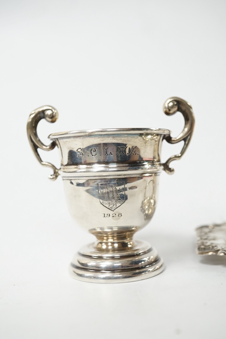 An Edwardian small silver baluster mug, Robert Pringle & Sons, Chester, 1906, 78mm, together with small silver trophy cup, a sterling pin tray and a silver condiment spoon. Condition - fair
